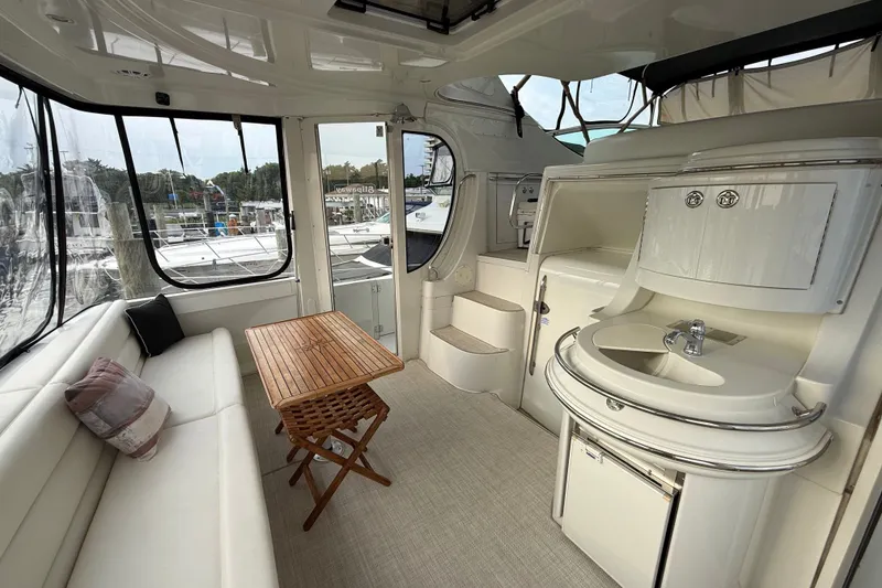 Slide: The Image of Interior of 2003 Carver 466 Motor Yacht with seating, table, and kitchenette. - 8