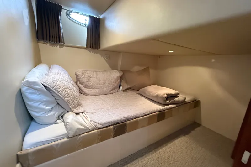 Slide: The Image of Cozy cabin interior of 2003 Carver 466 Motor Yacht with bed and porthole window. - 50