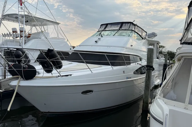 Slide: The Image of 2003 Carver 466 Motor Yacht docked at marina under cloudy sky. - 4