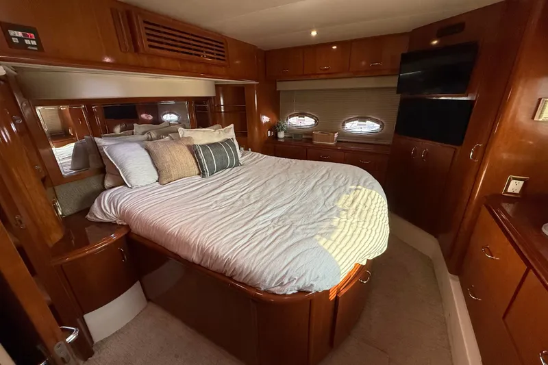 Slide: The Image of Luxurious bedroom interior of 2003 Carver 466 Motor Yacht with wood finishes and cozy bedding. - 31