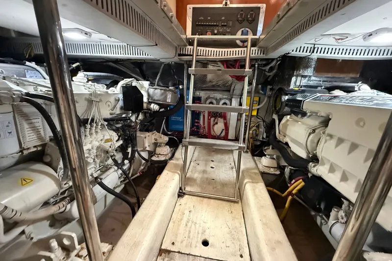 Slide: The Image of Engine room of a 2003 Carver 466 Motor Yacht, showcasing dual engines and control panel. - 51