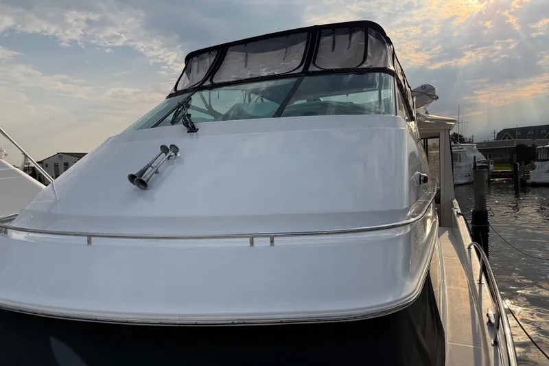 Slide: The Image of 2003 Carver 466 Motor Yacht docked under a partly cloudy sky. - 7