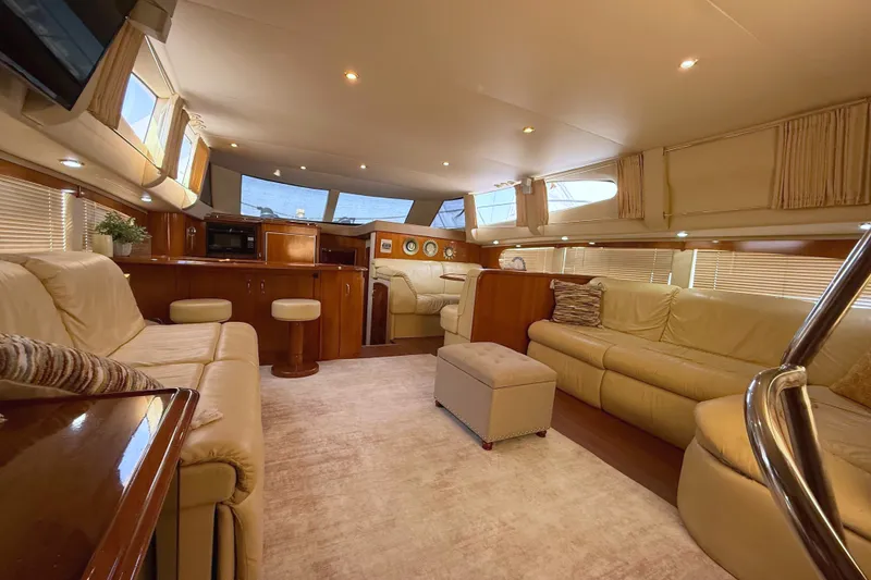 Slide: The Image of Luxurious interior of a 2003 Carver 466 Motor Yacht with plush seating and elegant wood finishes. - 18