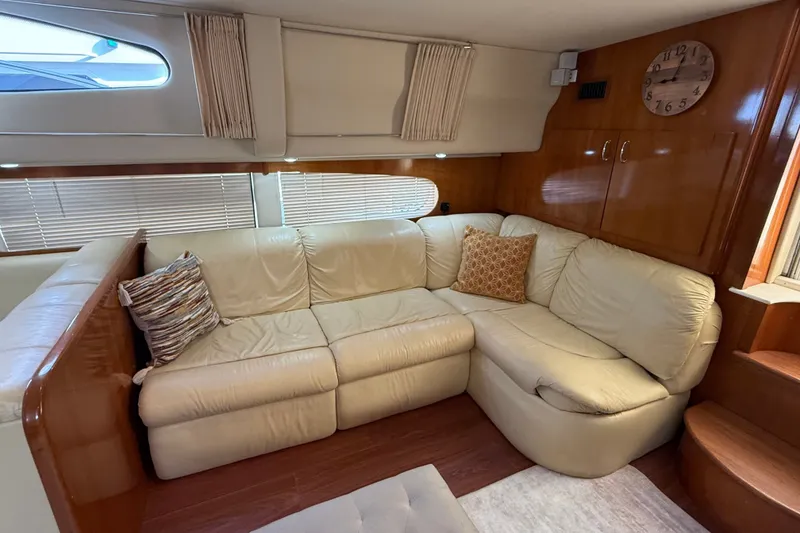 Slide: The Image of Luxurious interior of 2003 Carver 466 Motor Yacht with cream leather seating and wooden accents. - 23