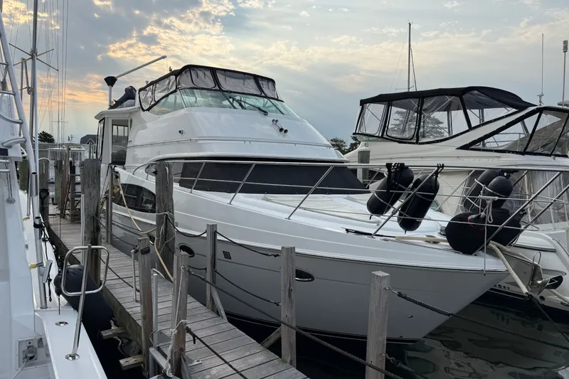 Slide: The Image of 2003 Carver 466 Motor Yacht docked at marina under cloudy sky. - 3