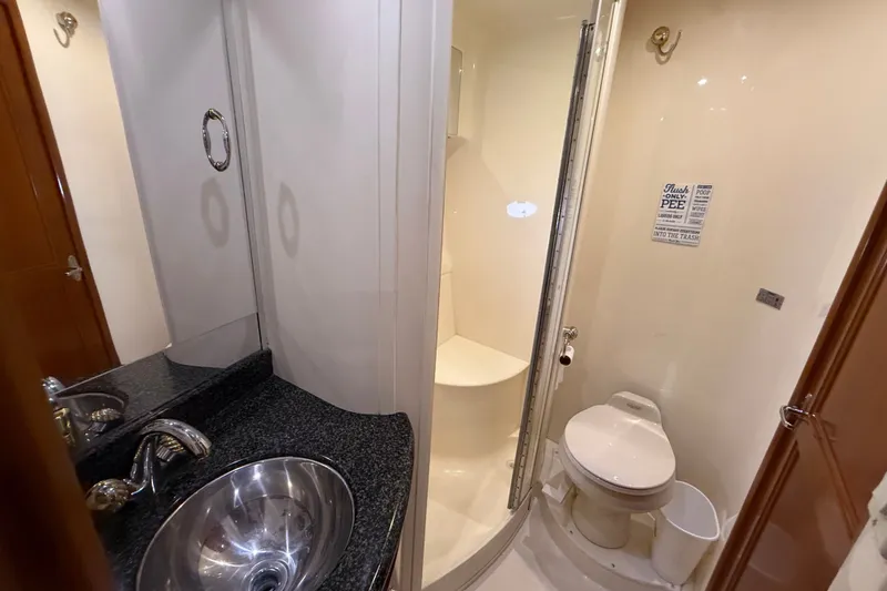 Slide: The Image of Bathroom interior of 2003 Carver 466 Motor Yacht with sink, toilet, and shower. - 46