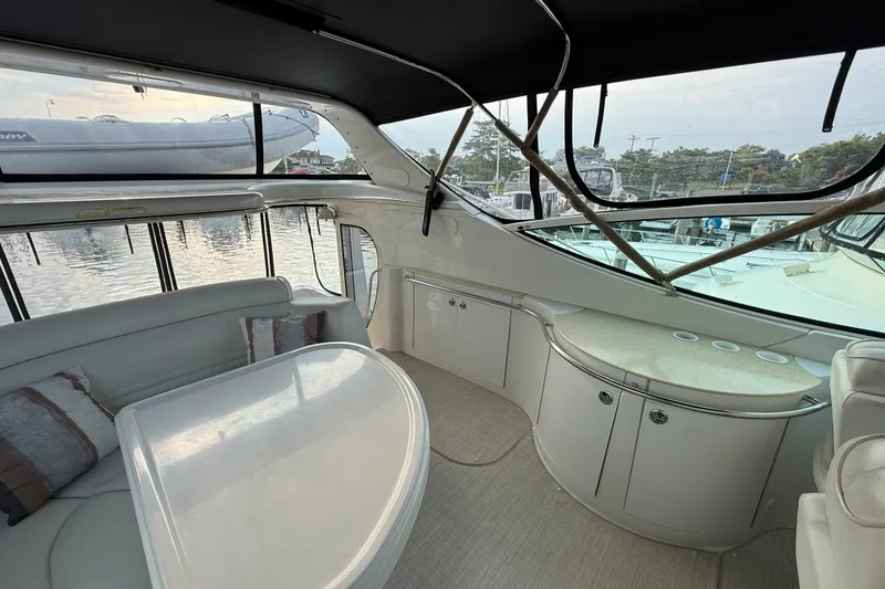 Slide: The Image of Interior of 2003 Carver 466 Motor Yacht with elegant seating and panoramic windows. - 12