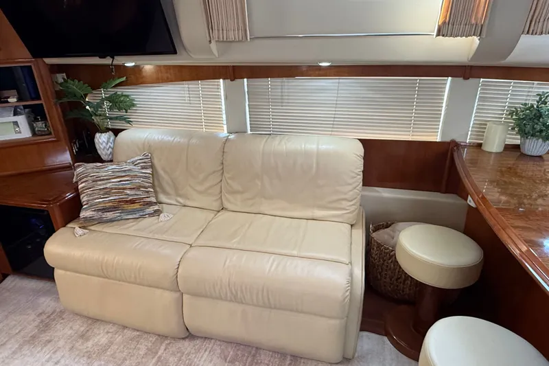 Slide: The Image of Luxurious interior of 2003 Carver 466 Motor Yacht with beige leather sofa and elegant decor. - 24