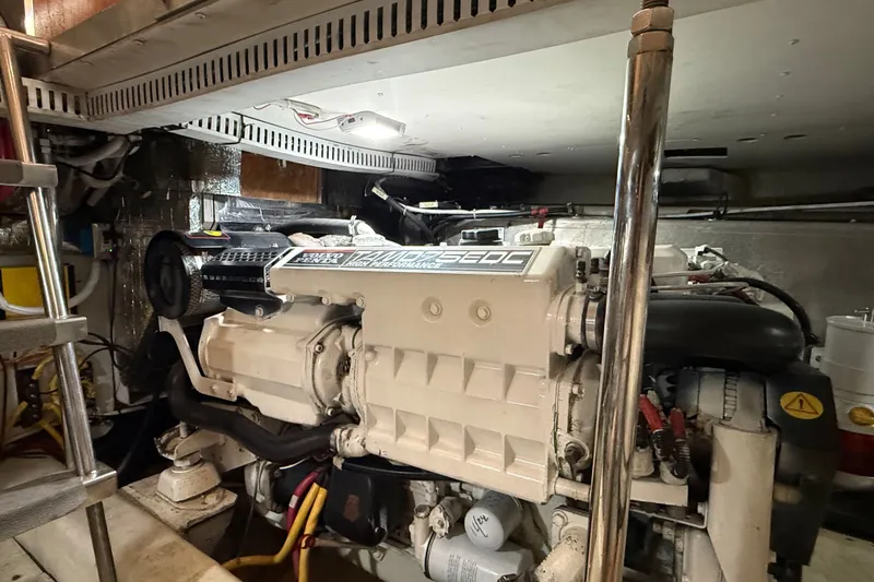Slide: The Image of Engine room of a 2003 Carver 466 Motor Yacht, featuring a Volvo Penta engine. - 54