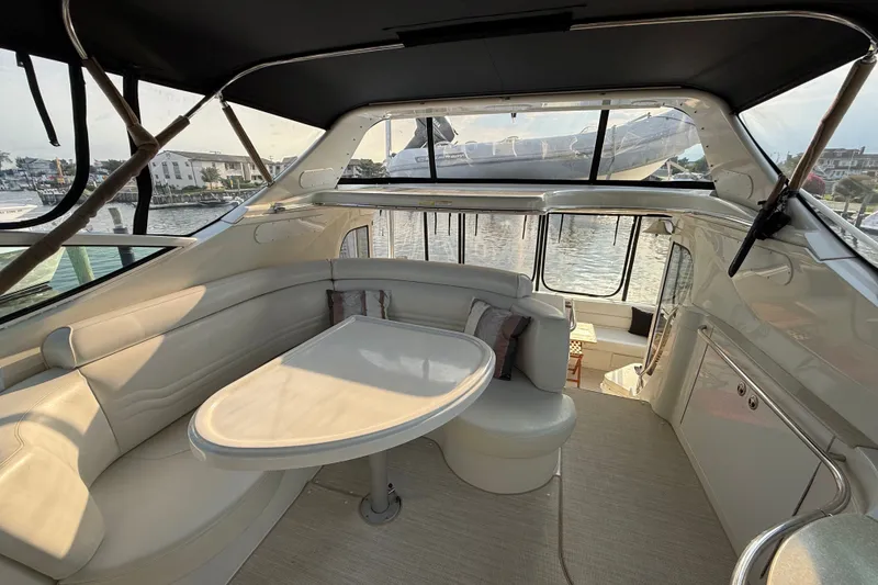 Slide: The Image of Interior of 2003 Carver 466 Motor Yacht with elegant seating and waterfront view. - 11