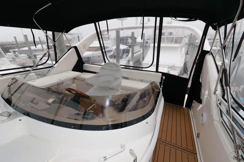 Slide: The Image of 2001 Sea Ray 450 Express Bridge cockpit with helm and seating area. - 6