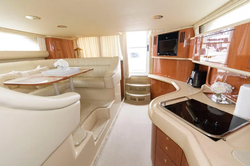 Slide: The Image of Interior of 2001 Sea Ray 450 Express Bridge yacht with modern kitchen and dining area. - 17