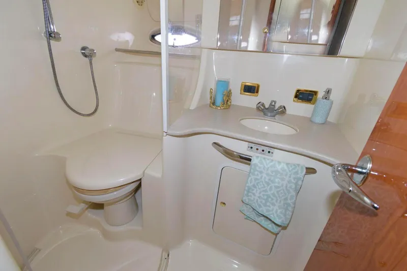 Slide: The Image of 2001 Sea Ray 450 Express Bridge bathroom with shower, sink, and toilet. - 22
