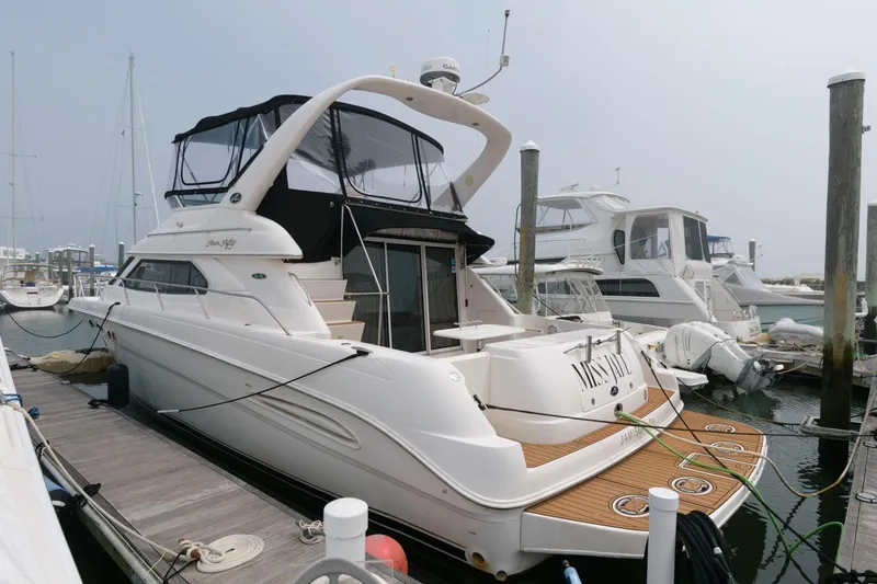 The Image of 2001 Sea Ray 450 Express Bridge yacht docked at marina. - 0