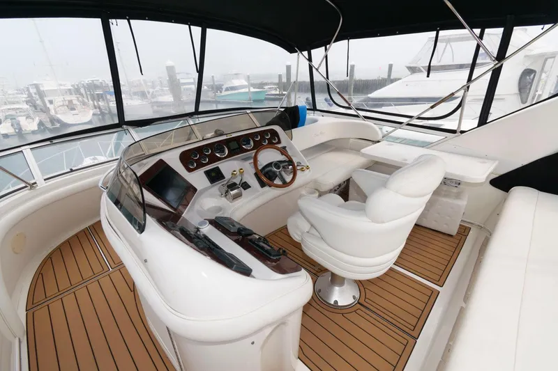 Slide: The Image of 2001 Sea Ray 450 Express Bridge helm with modern controls and panoramic view. - 5