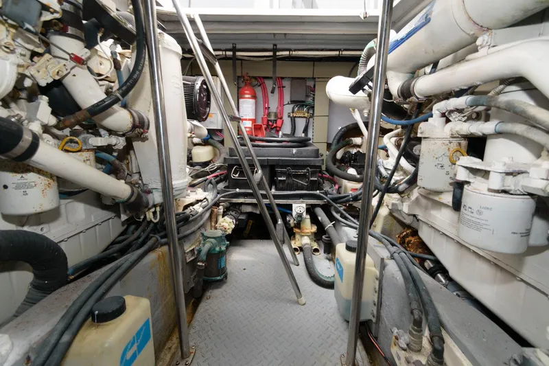 Slide: The Image of Engine room of a 2001 Sea Ray 450 Express Bridge yacht with various mechanical components. - 24