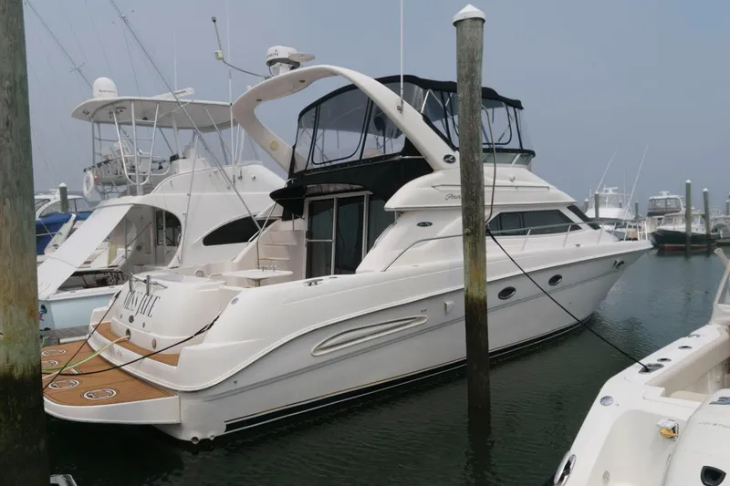 Slide: The Image of 2001 Sea Ray 450 Express Bridge yacht docked at marina. - 1