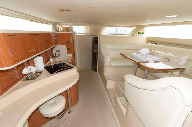 Slide: The Image of Interior of 2001 Sea Ray 450 Express Bridge yacht with kitchen and dining area. - 14