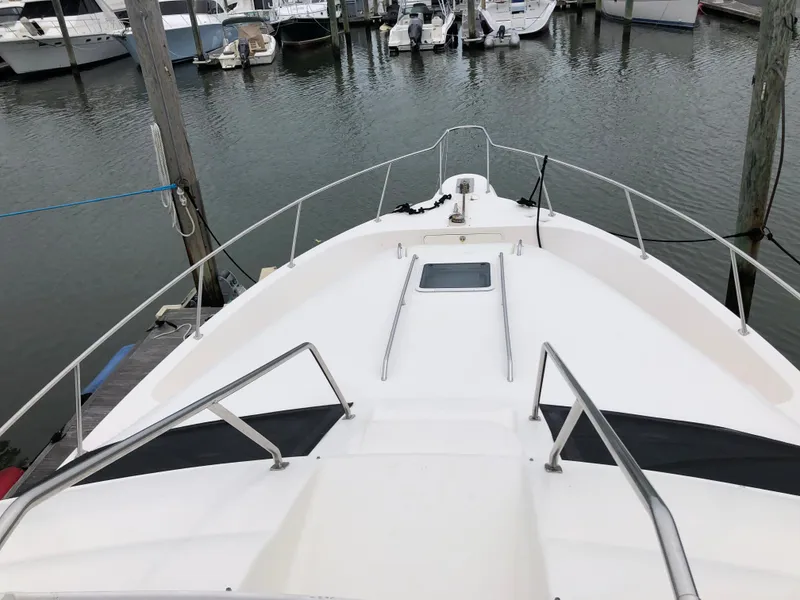 Slide: The Image of 2001 Sea Ray 450 Express Bridge bow view at marina. - 4