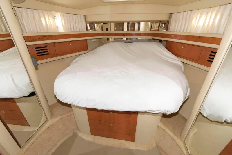 Slide: The Image of Interior cabin of a 2001 Sea Ray 450 Express Bridge yacht with a cozy bed. - 18