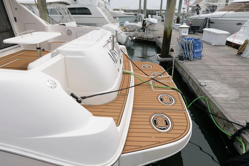 Slide: The Image of 2001 Sea Ray 450 Express Bridge docked at marina with teak swim platform. - 12