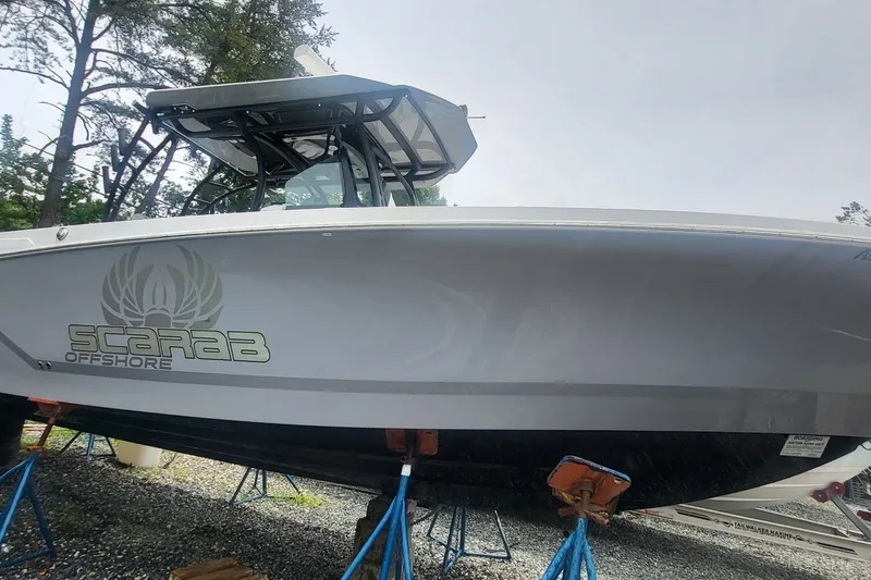 The Image of 2023 Wellcraft 302 Fisherman boat on stands, featuring Scarab Offshore branding. - 0