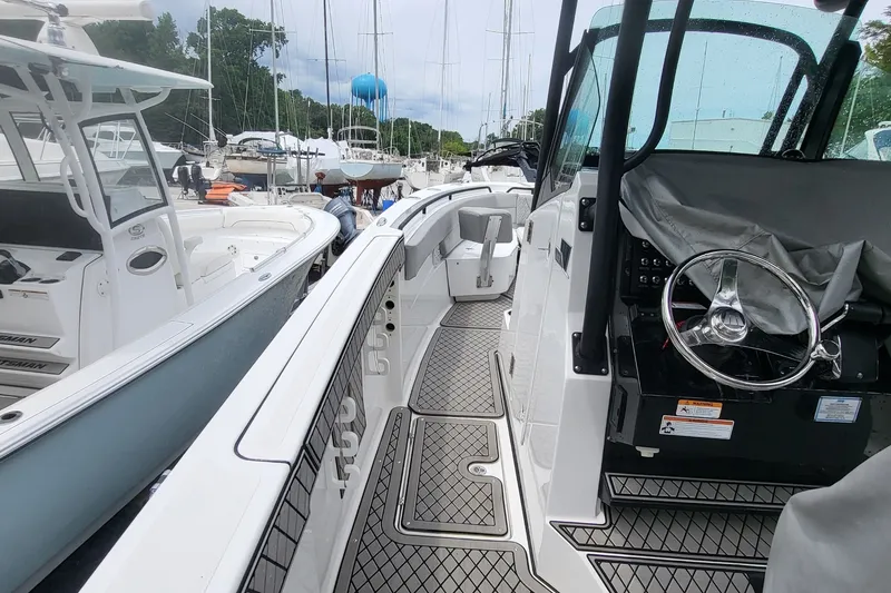 Slide: The Image of 2023 Wellcraft 302 Fisherman boat docked, showcasing sleek design and modern features. - 6
