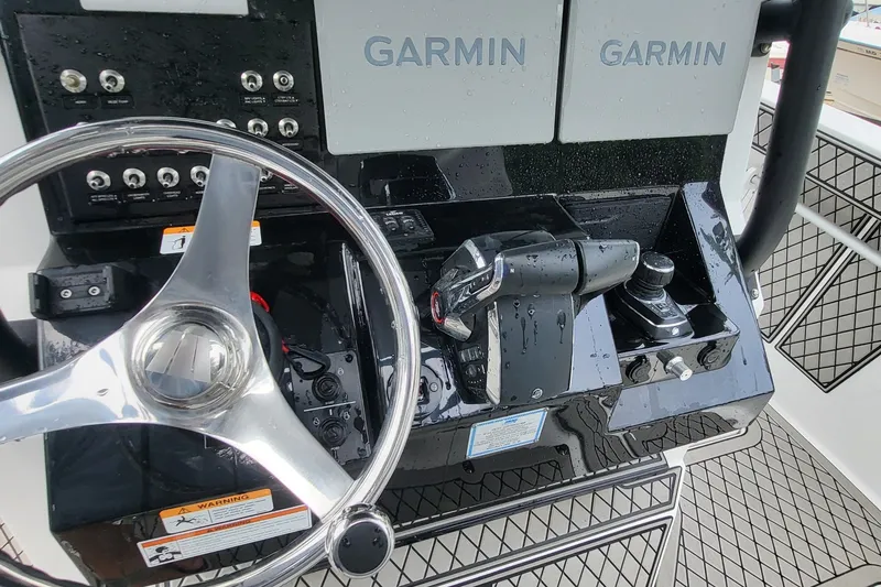 Slide: The Image of 2023 Wellcraft 302 Fisherman helm with Garmin displays and steering wheel. - 13