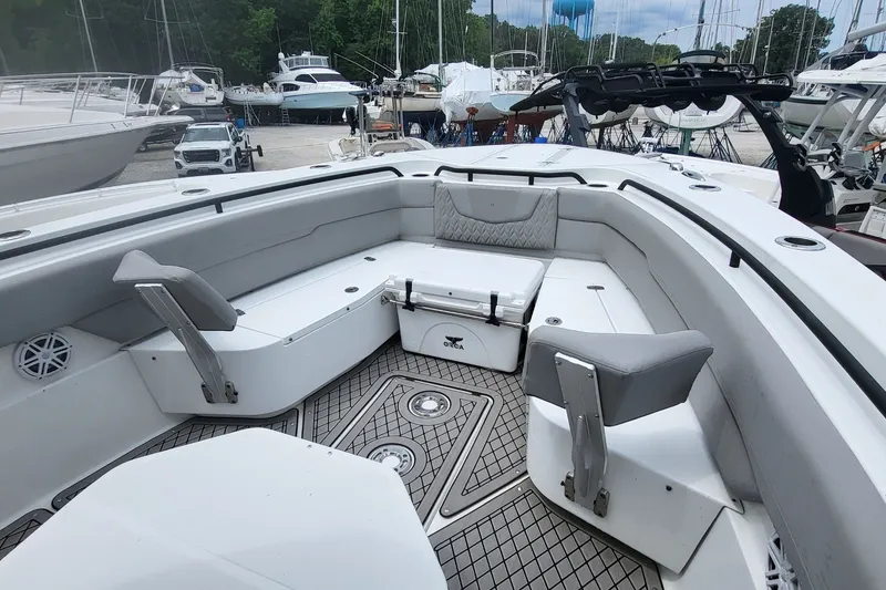 Slide: The Image of 2023 Wellcraft 302 Fisherman boat interior with seating and storage, docked at marina. - 5