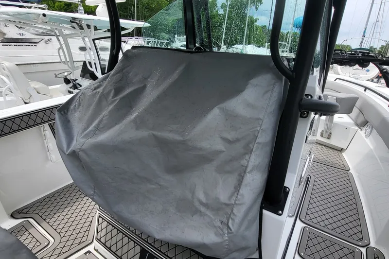 Slide: The Image of 2023 Wellcraft 302 Fisherman boat with protective cover on console, featuring sleek design and modern amenities. - 15