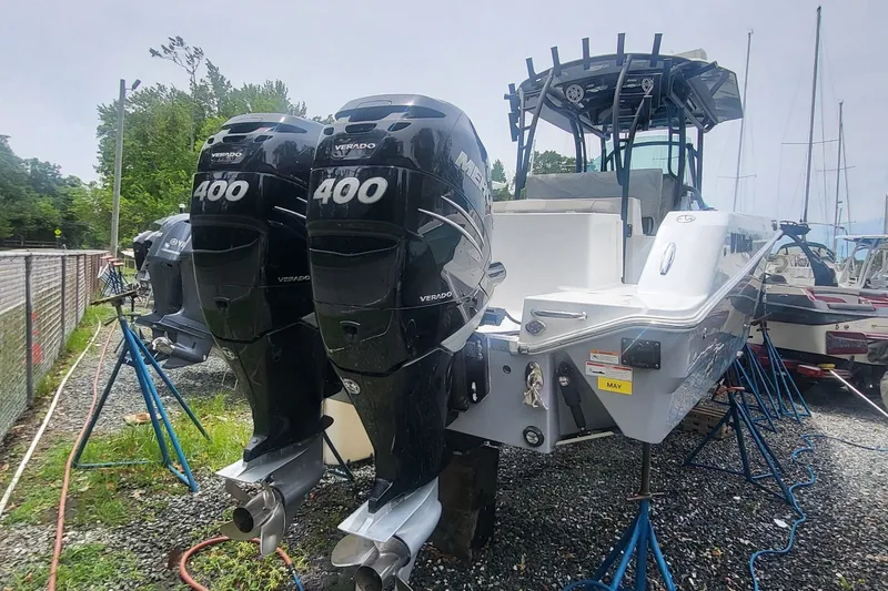 Slide: The Image of 2023 Wellcraft 302 Fisherman boat with dual Mercury 400 engines on stands. - 1