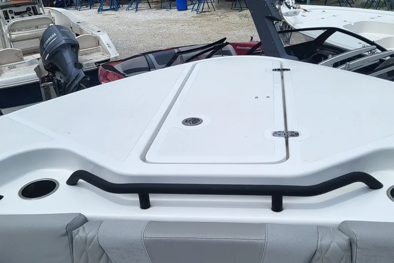 Slide: The Image of 2023 Wellcraft 302 Fisherman boat deck with Yamaha engine in a marina setting. - 19