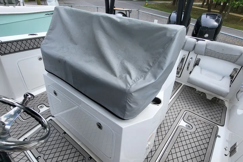 Slide: The Image of 2023 Wellcraft 302 Fisherman boat interior with covered console and seating area. - 10
