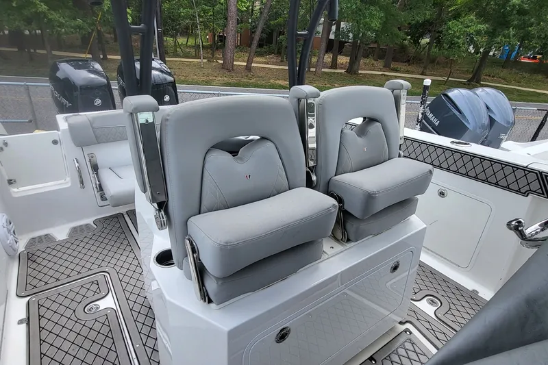 Slide: The Image of 2023 Wellcraft 302 Fisherman boat interior with dual seats and outboard motors. - 9