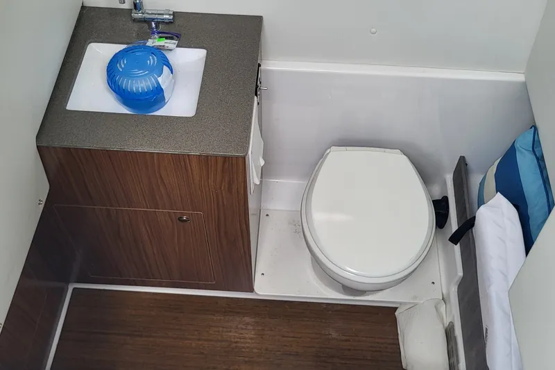 Slide: The Image of 2023 Wellcraft 302 Fisherman boat bathroom with sink and toilet. - 16
