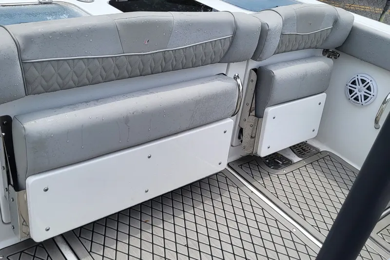 Slide: The Image of 2023 Wellcraft 302 Fisherman boat interior with cushioned seating and wet deck. - 17