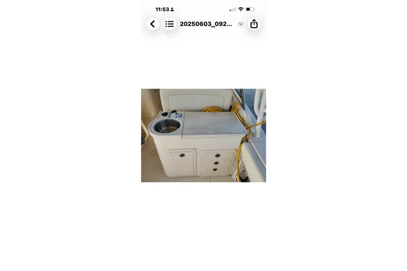Slide: The Image of 2017 Grady-White Freedom 307 boat sink and storage area with yellow rope. - 27