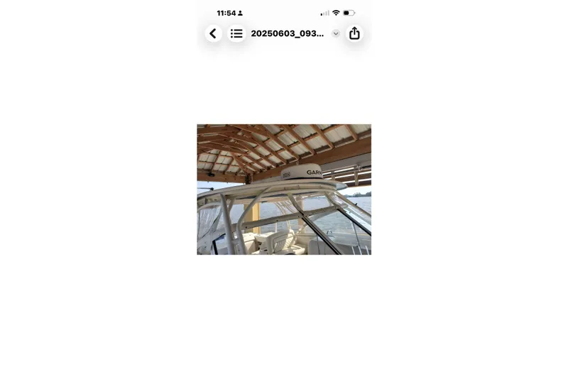 Slide: The Image of 2017 Grady-White Freedom 307 boat docked under a wooden canopy. - 21