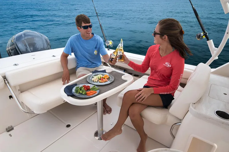 Slide: The Image of Manufacturer Provided Image: Couple enjoying drinks and snacks on a 2017 Grady-White Freedom 307 boat. - 15
