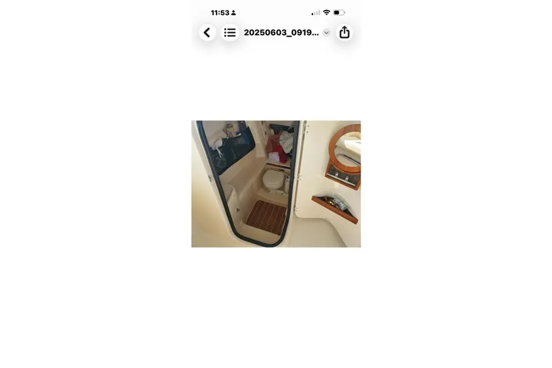 Slide: The Image of Interior of 2017 Grady-White Freedom 307 boat, featuring a compact bathroom area. - 32