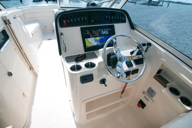 Slide: The Image of Manufacturer Provided Image: 2017 Grady-White Freedom 307 boat helm with steering wheel and navigation system. - 9