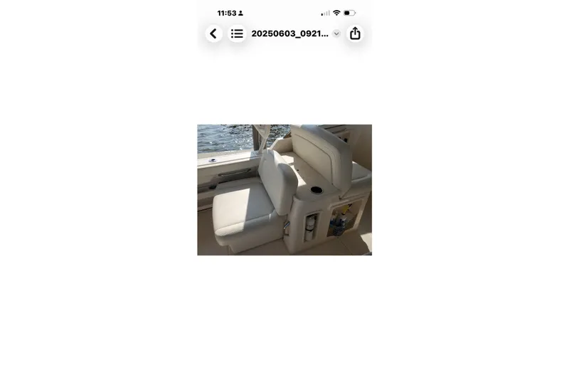 Slide: The Image of 2017 Grady-White Freedom 307 boat interior with cushioned seating and cup holder. - 26