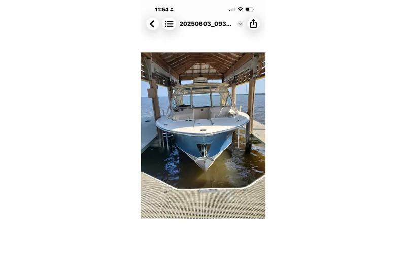 The Image of 2017 Grady-White Freedom 307 boat docked under a wooden shelter. - 20