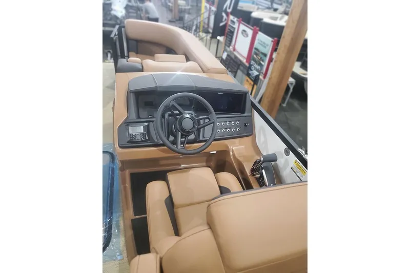 Slide: The Image of Luxurious 2027 Alera A24Q boat interior with modern steering console and tan seating. - 6