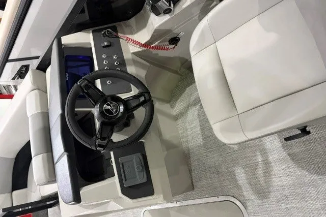 Slide: The Image of Interior of 2027 Alera A24Q boat featuring steering wheel and seating area. - 12