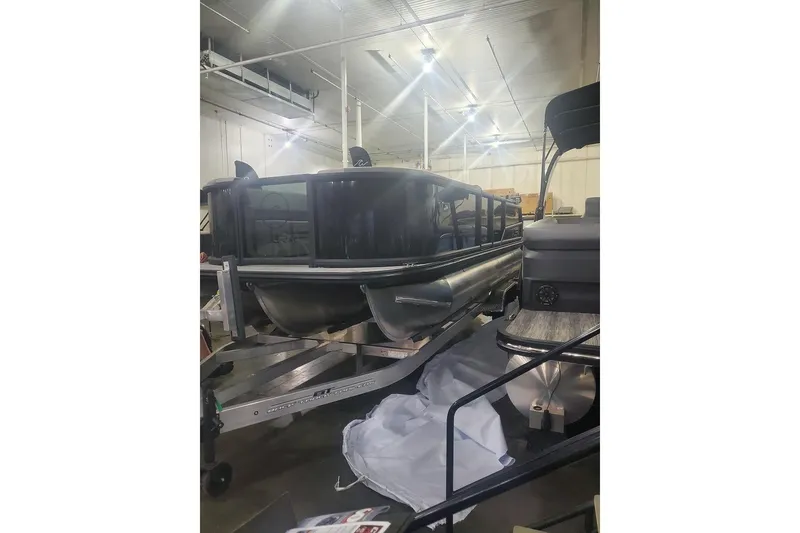 Slide: The Image of 2027 Alera A24Q pontoon boat in a warehouse setting. - 2