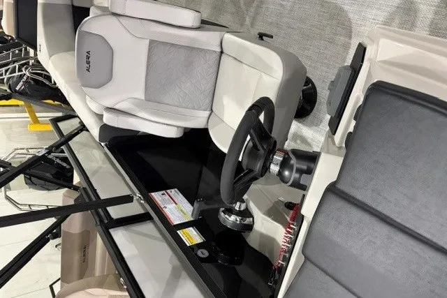 Slide: The Image of Interior of 2027 Alera A24Q boat featuring steering wheel and seating. - 8