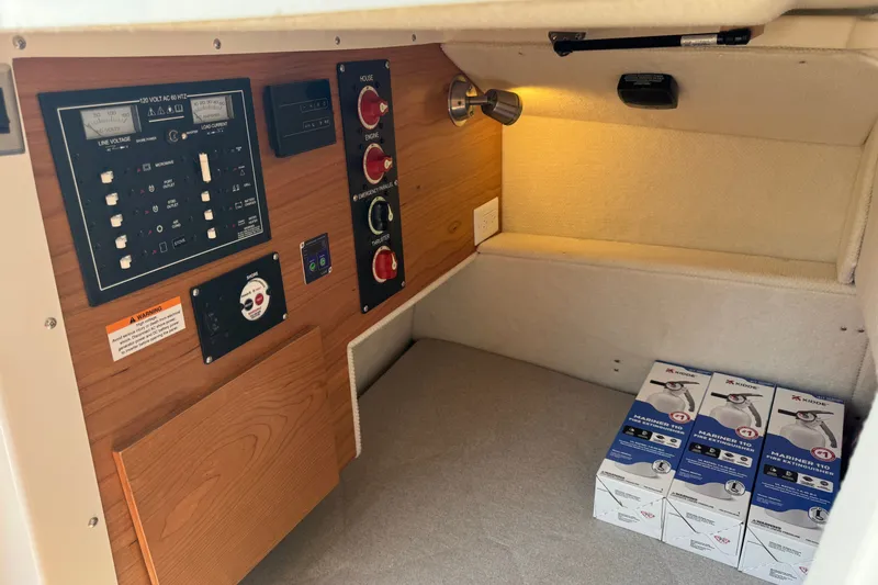 Slide: The Image of Electrical panel and storage area inside 2027 Cutwater C-248 Coupe boat cabin. - 14
