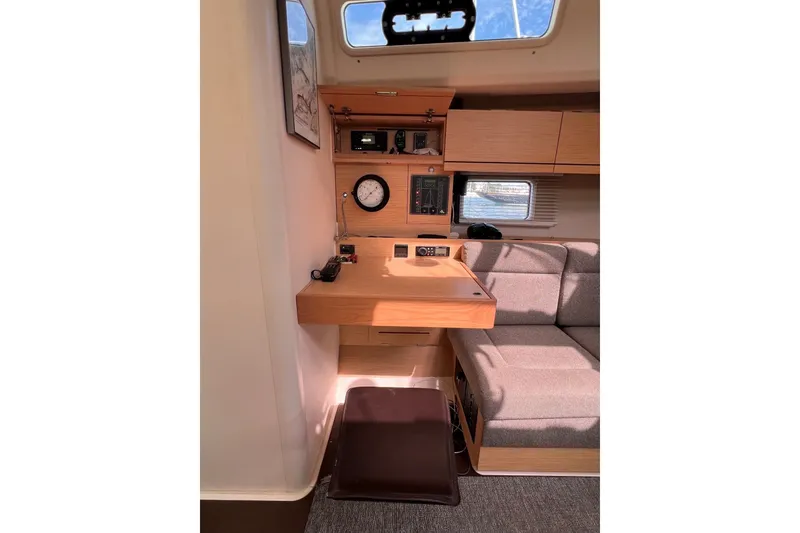 Slide: The Image of Interior of 2020 Hanse 458 yacht with navigation station and seating area. - 53