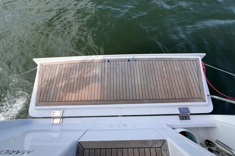 Slide: The Image of Teak swim platform on 2020 Hanse 458 yacht, above green water. - 33